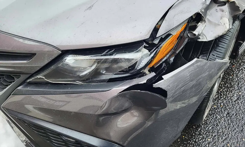 Front corner collision damage with broken headlight and bumper Front corner collision damage with broken headlight and bumper