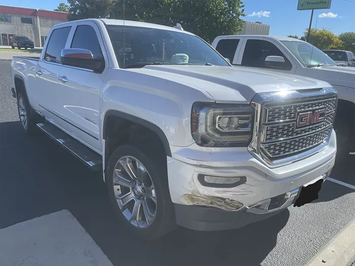 GMC Sierra front bumper damage before repair
