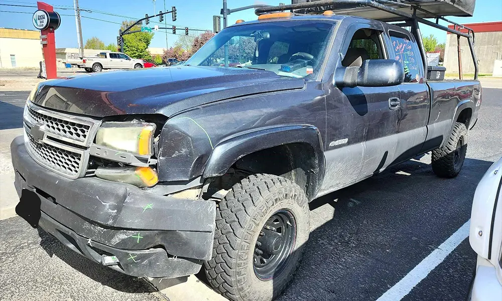 Damaged pickup truck before collision repair