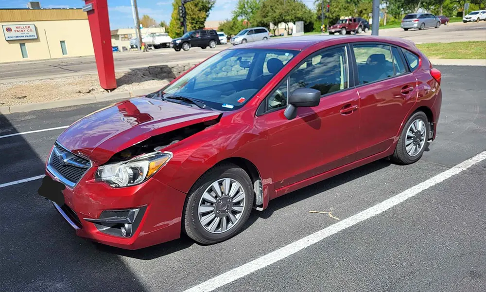 Red vehicle with front end damage Red vehicle with front end damage