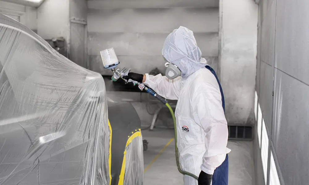 Professional vehicle paint restoration in a paint booth