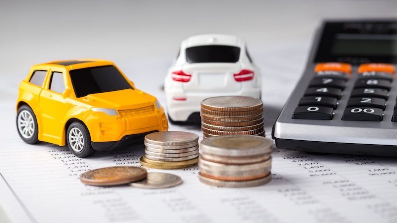 Cars and coins with calculator on financial statement collision repair timeline