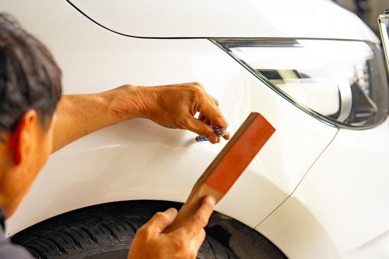 Removing dents on the car. PDR technology. Car body repair without painting. Hammer. High quality photo