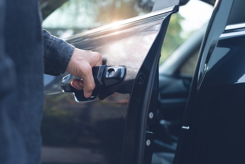 Close up of a male hand opening a car door